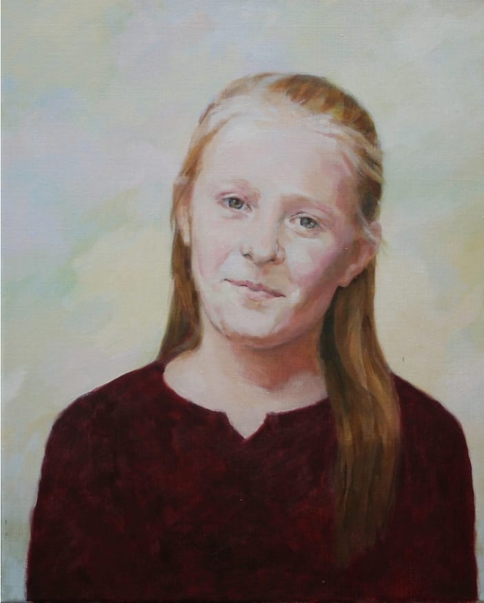 Smiling girl with flowing red hair.