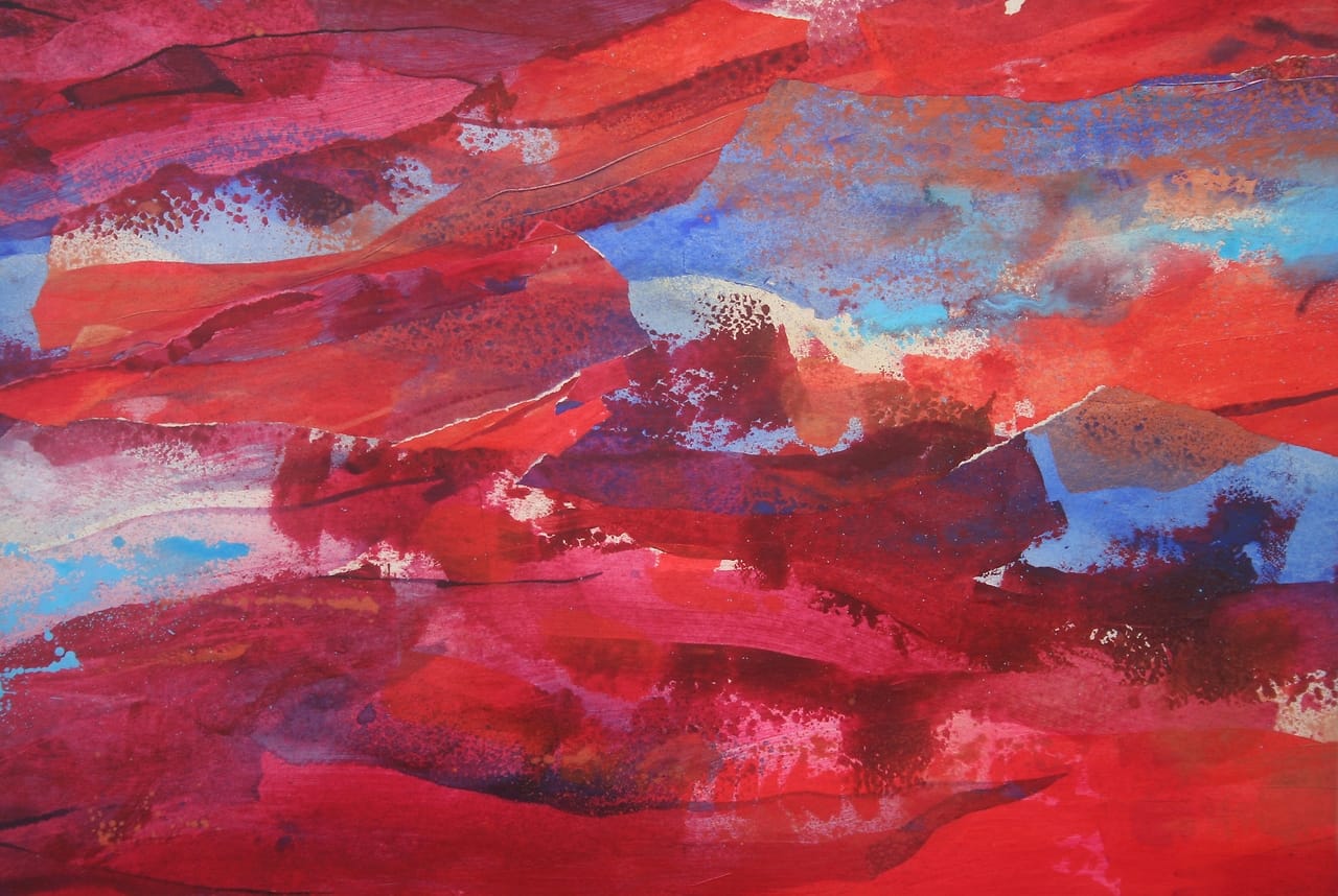 Abstract mountainous landscape. Collage of shredded pieces of painted paper in different shades of red.